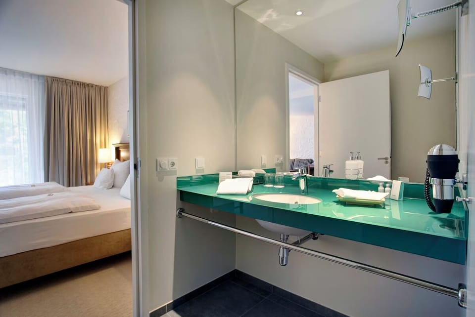 Refresh at the sleek glass vanity after a restful night.