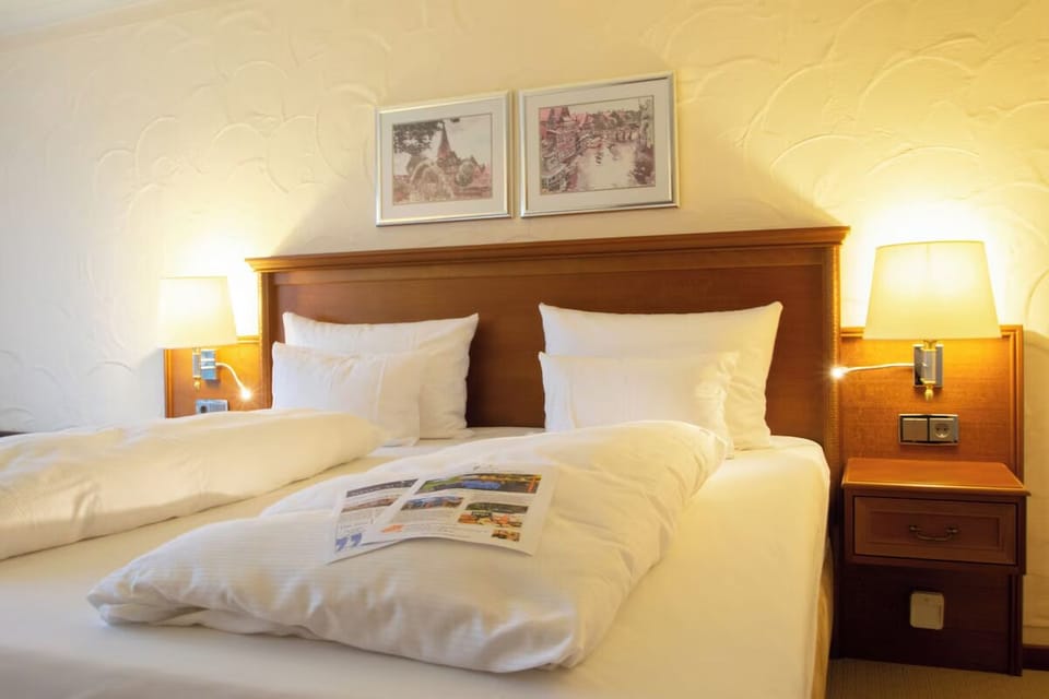 Drift off fast in a cloud-soft bed with bedside glow.