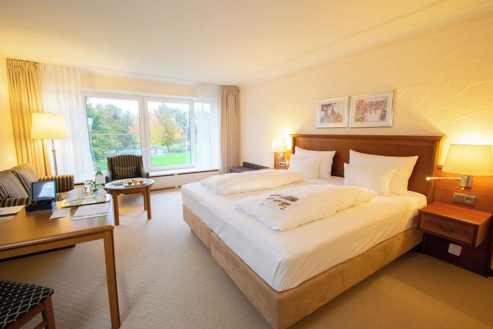 Sink into crisp linens in a sunlit, spacious king room.