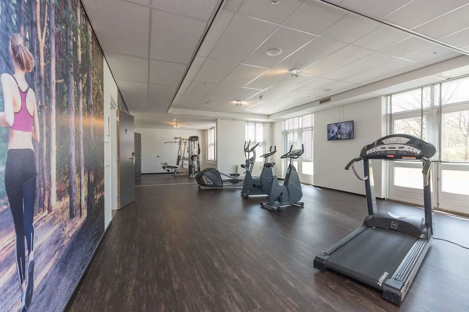 Energize your day in the bright gym with modern cardio.