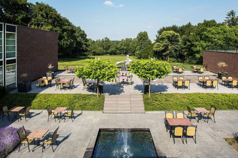 Unwind outdoors with café seating and sweeping green views.