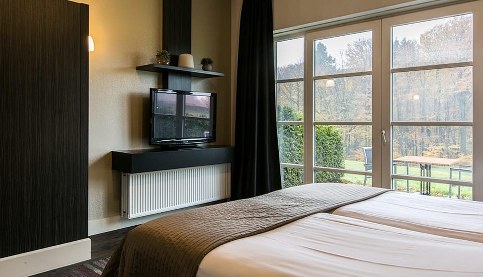 Settle into a quiet bedroom with warm, modern finishes.