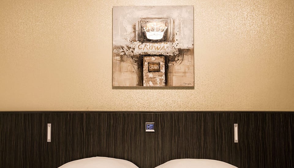 Unwind into a restful night beneath warm, modern headboard lighting.