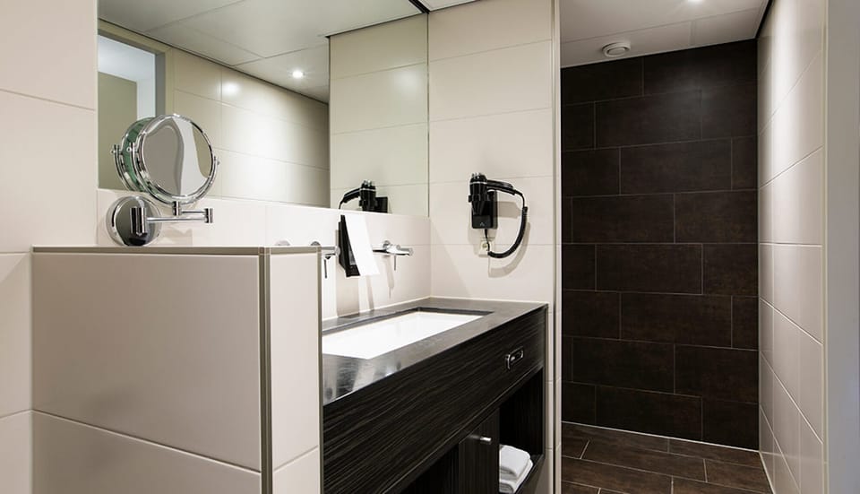 Refresh easily in a sleek walk-in shower bathroom.