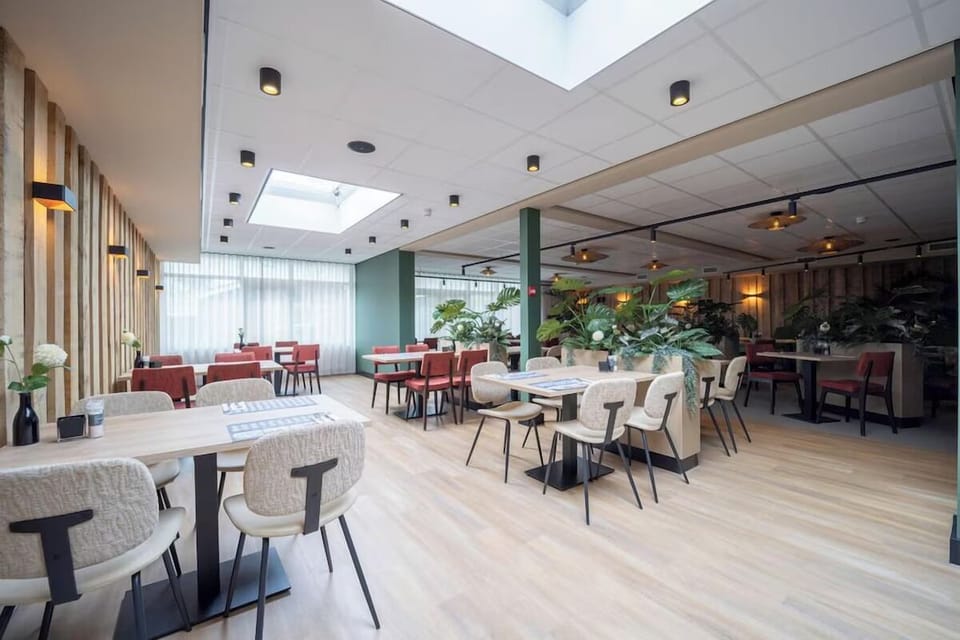Enjoy a bright breakfast setting under skylights and soft greenery.