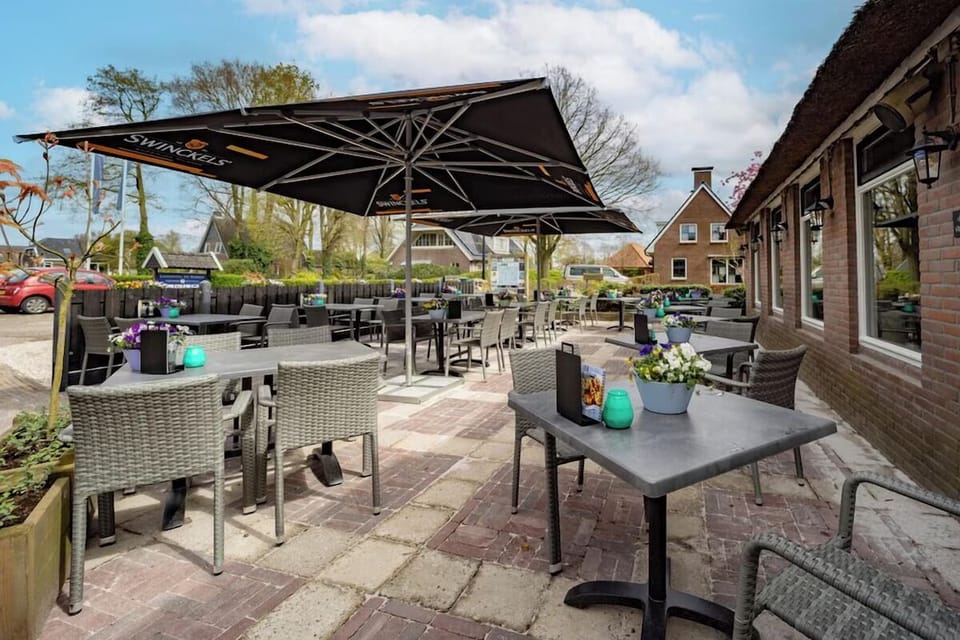 Sip drinks outside on the sunny terrace with roomy tables.