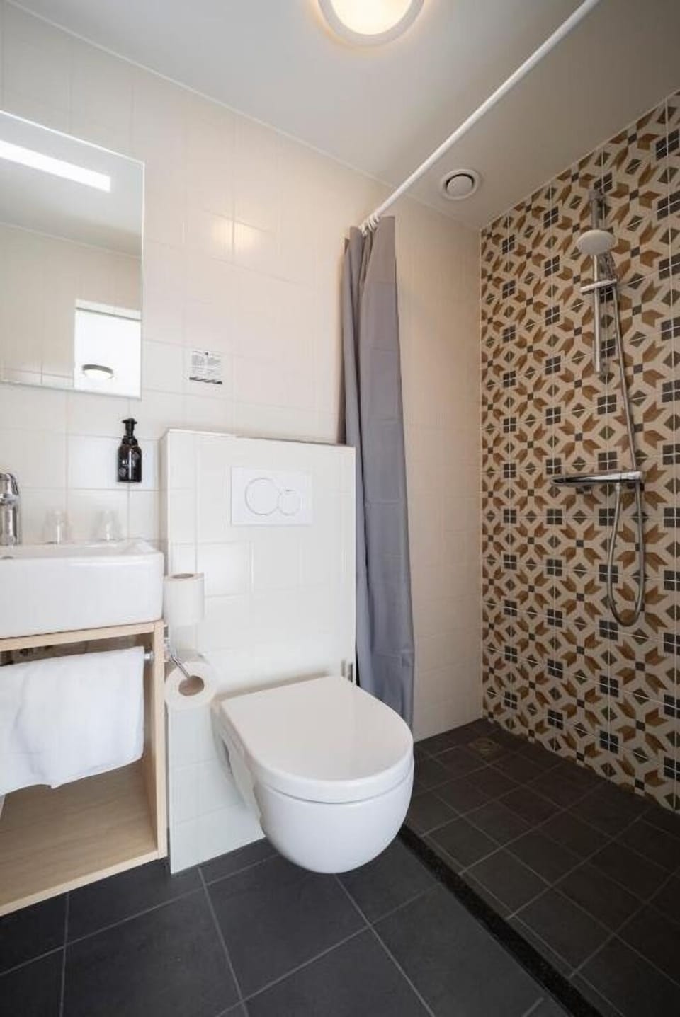 Rinse off under the rain shower in a stylish tiled nook.