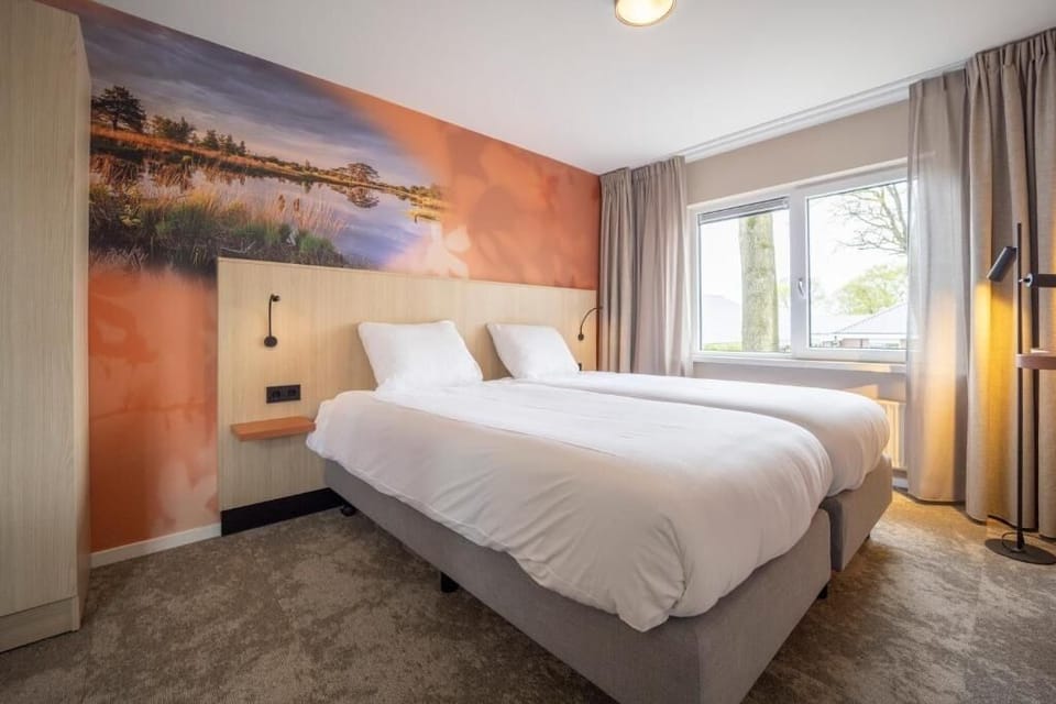 Wake up refreshed in sunlit beds with serene window view.