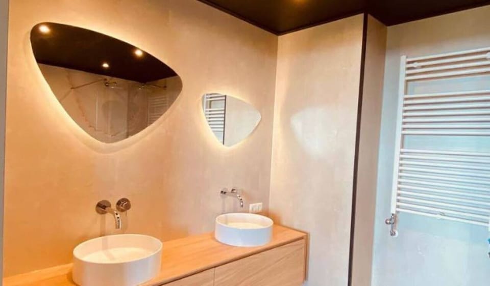 Refresh each morning at the sleek vanity with warm lighting.