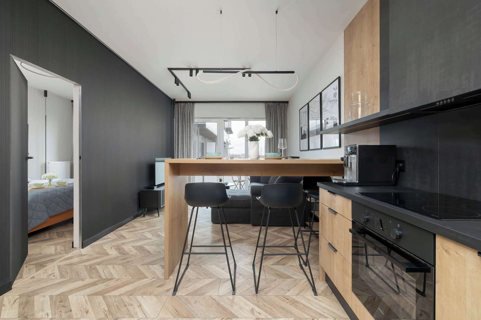 A kitchen view with modern appliances and geometric flooring patterns.