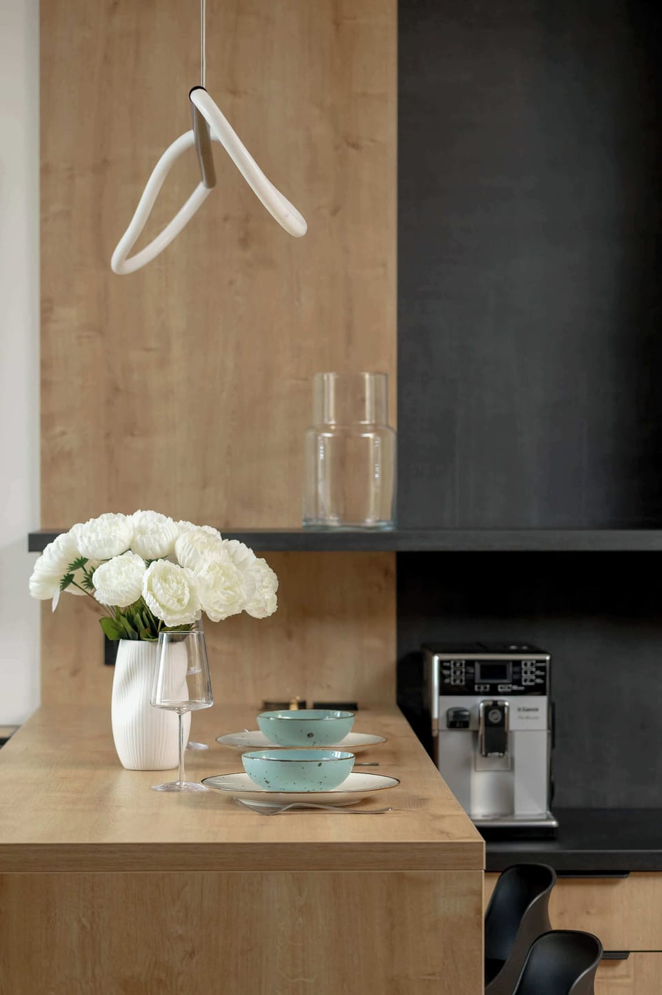 A decorative interior detail with a small flower arrangement placed on a wooden shelf.