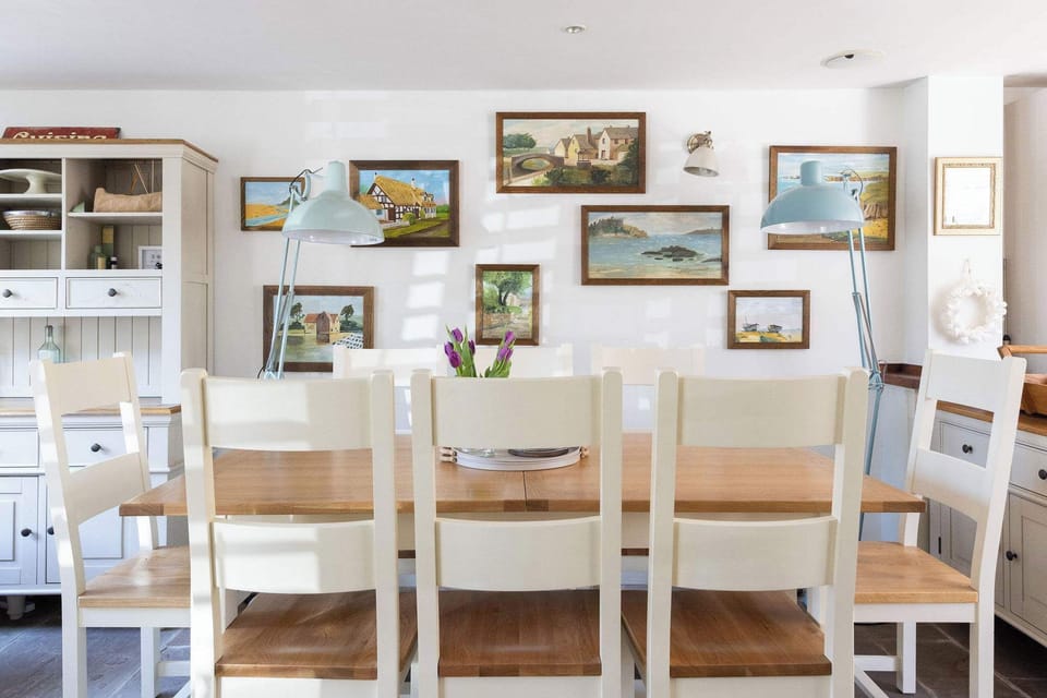 Bright dining space with coastal artwork and seating for everyone