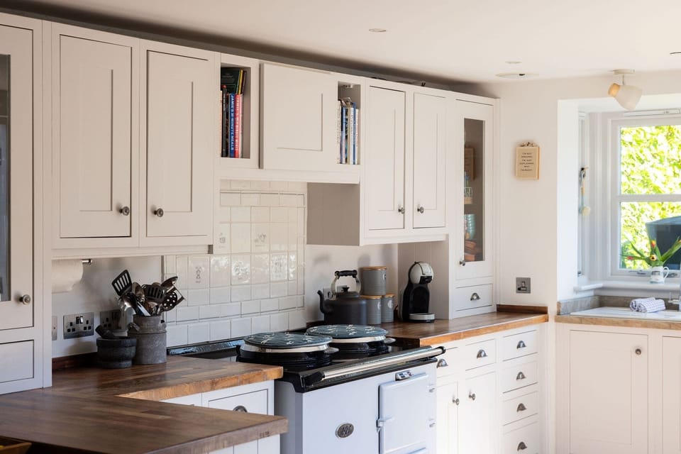 Beautiful country kitchen with range cooker and handcrafted cabinetry
