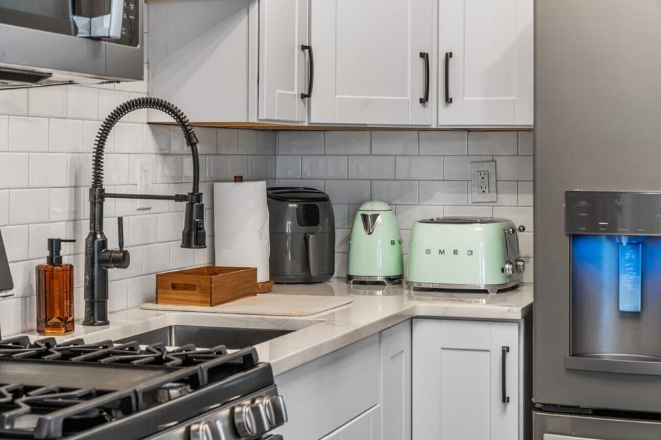 Kitchen stocked with an air fryer, kettle, and toaster