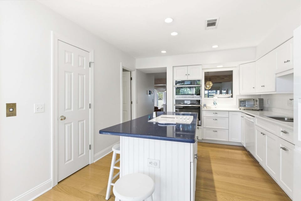 Fully equipped kitchen with ample counter space, stainless double ovens, and a breakfast bar that invites slow mornings.
