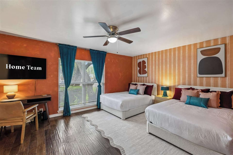 Bedroom 1: Relax and recharge in this modern bedroom featuring two comfortable double beds and a dedicated workspace. Relax, catch up on your favorite shows on the flat-screen TV, or simply unwind in a space designed for both productivity and rest.