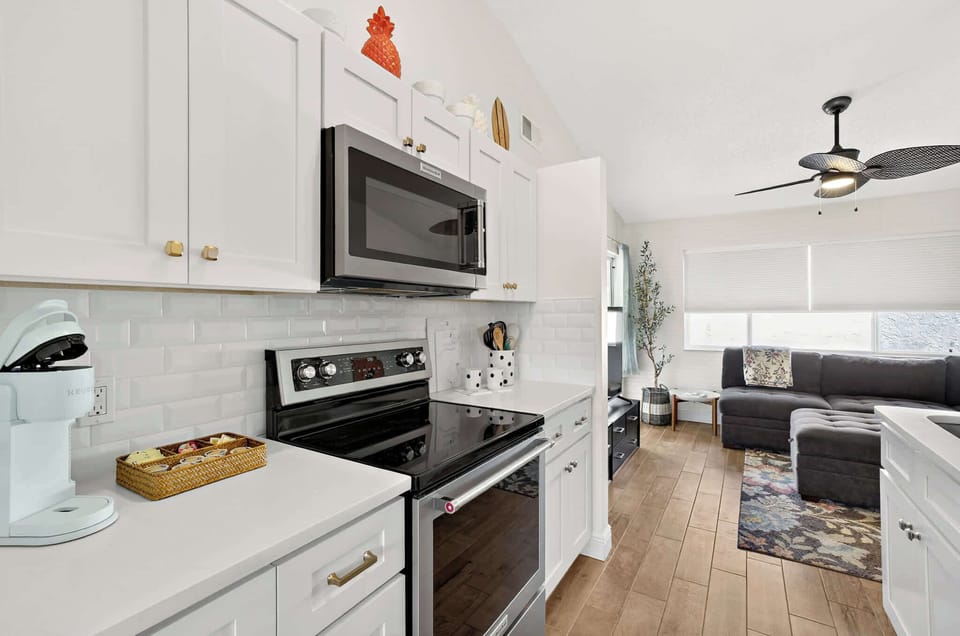 Stainless Steel Range and Microwave with White Cabinets
