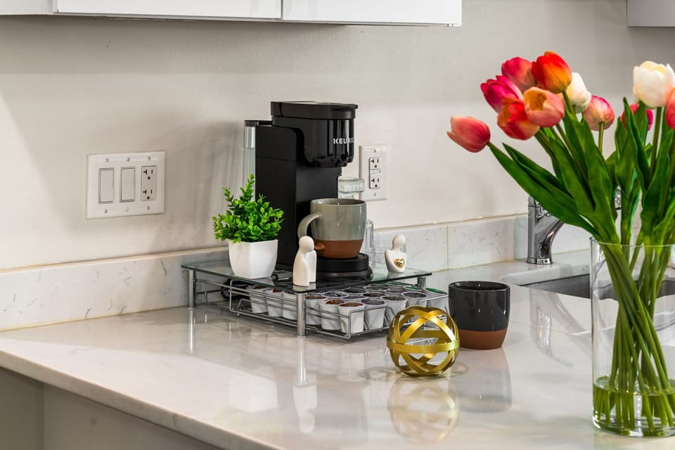 A dedicated coffee setup to start your mornings right, set in a clean, well-kept kitchen that keeps everything within reach.