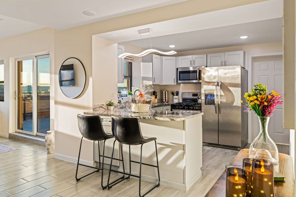 Cook and connect in an open kitchen with island seating for casual meals.