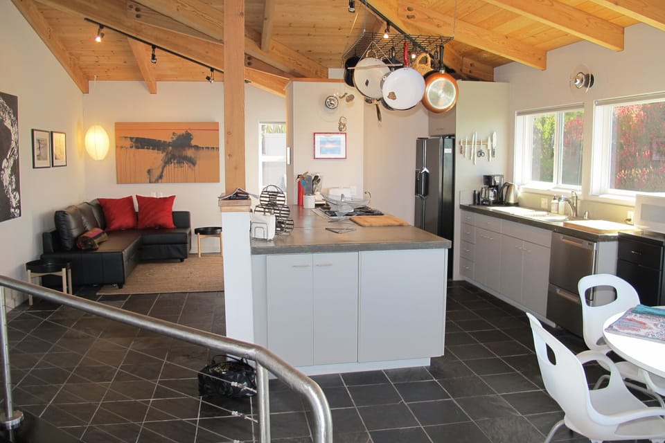 Kitchen, bar and den area with access to outdoor BBQ