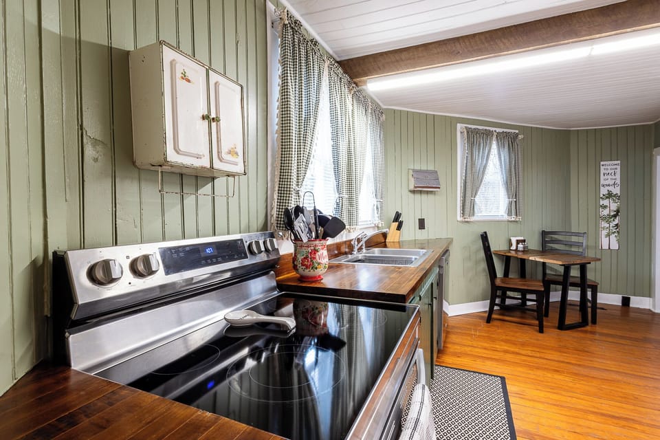 Modern glass top stove/oven with pots and pans available for cooking and baking.
