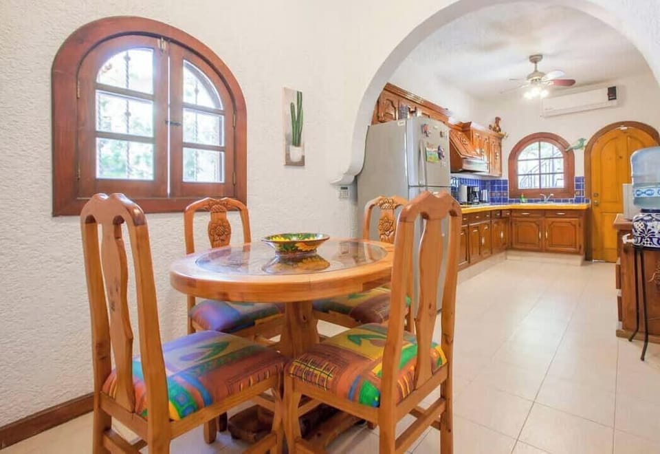 A 4-top dining table with cushioned chairs