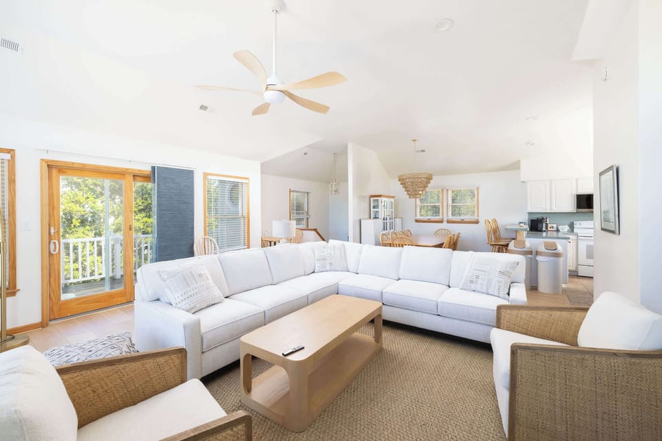 Top Level Living Area that flows into the dining area and fully equipped kitchen, leading to a private deck 