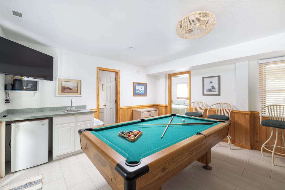 Game Room with pool table, comfortable seating, and a large TV for entertainment and kitchenette