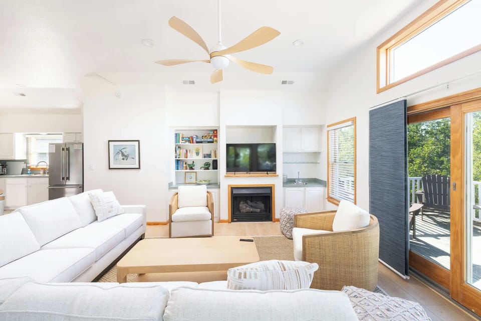 Top Level Living Area with a cozy fireplace, TV and access to a private deck with outdoor seating