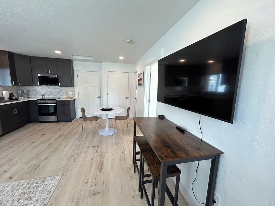 Settle into your open-concept retreat with a fully equipped kitchen, cozy dining nook, and entertainment ready for your favorite shows after a day of adventure.