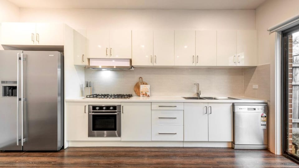Fully equipped kitchen with stainless steel appliances and ample bench space for easy meal preparation.