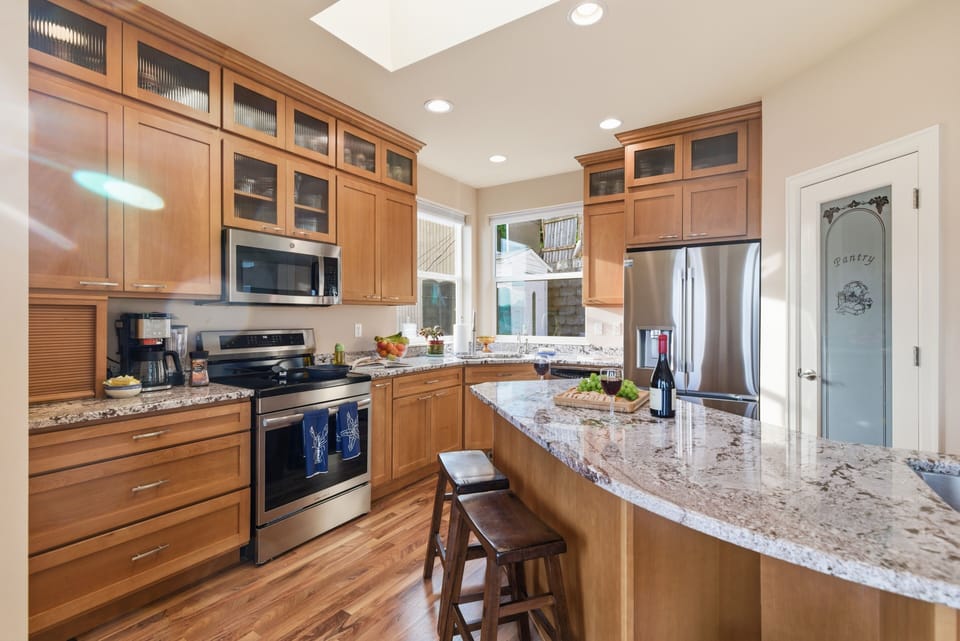 Spacious kitchen with bar seating and ample prep space.