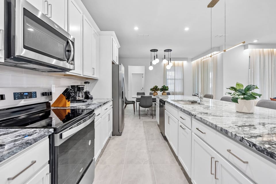 Experience a beautifully designed kitchen with sleek stainless steel appliances and elegant granite countertops, perfect for meal prep.