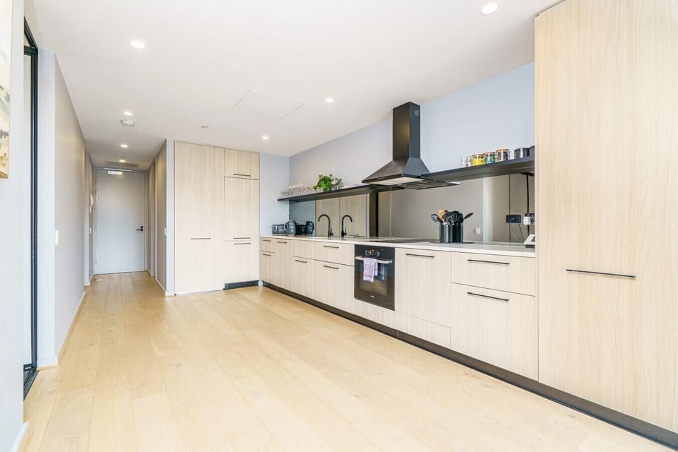 Bright and airy interiors flow seamlessly through the stylish kitchen and living spaces.