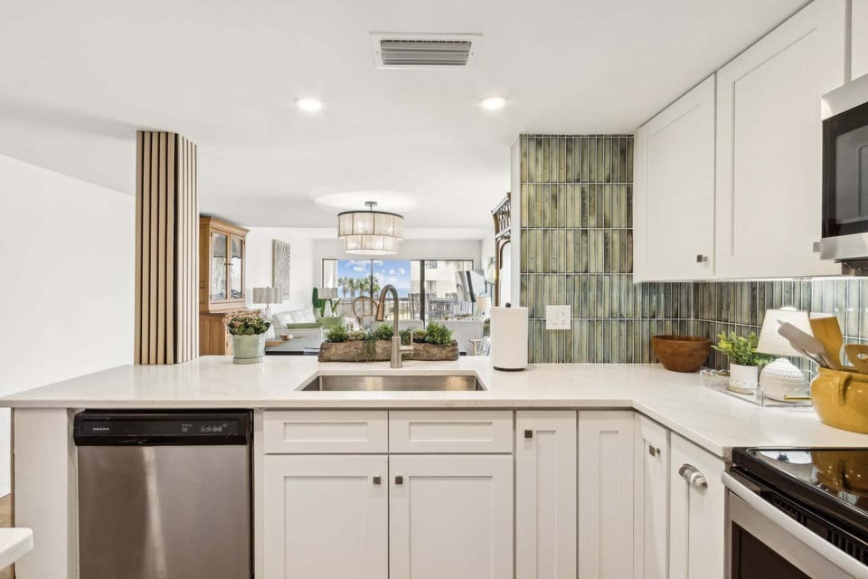 Newly Updated Kitchen with Quartz Countertops, Stainless Steel Appliances, and Stylish Tiled Backsplash
