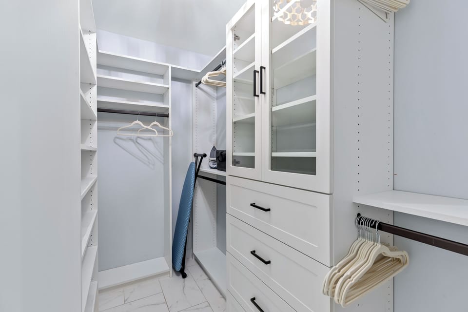 Walk-in closet in primary bedroom.