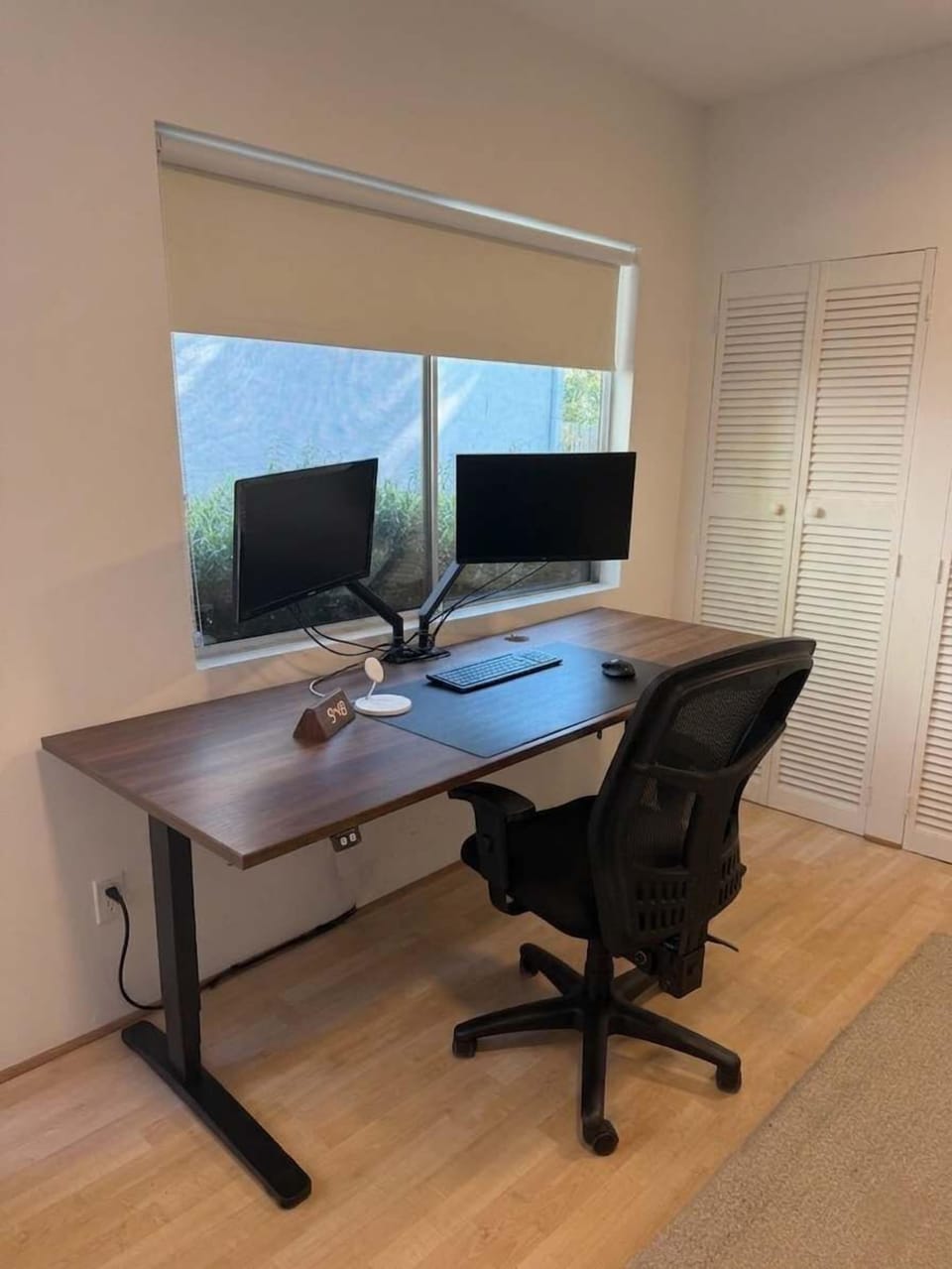 Inside, the studio is set up as a bright workspace with natural light, a dedicated desk setup, and a clean, open layout—ideal for remote work or creative use.