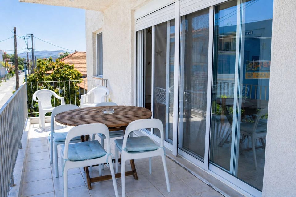 Sunny balcony with outdoor seating, ideal for breakfast, evening drinks, or enjoying the fresh air and relaxing sea views