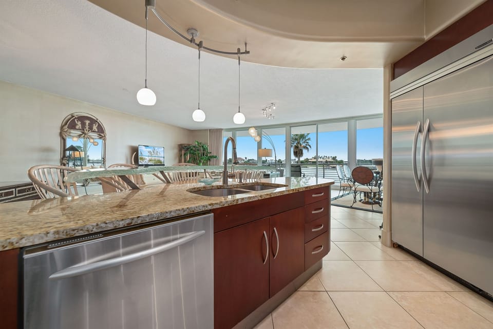 Imagine preparing delicious meals with ease in this well-appointed kitchen, all while staying connected with family and friends in the adjacent living and dining areas. This open-concept design is ideal for a relaxed coastal lifestyle.