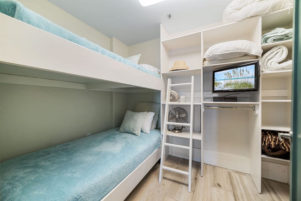 Versatile bunk bed room offering comfortable accommodations for guests or family. This space maximizes functionality and style, providing a cozy and inviting atmosphere.