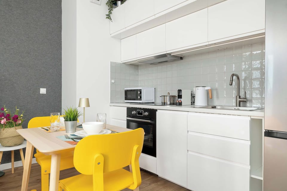 The sleek design of the kitchenette blending seamlessly with the living area.
