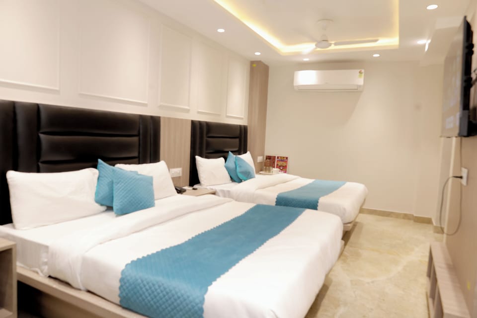 Deluxe Triple Room, City View | Desk, laptop workspace, free WiFi