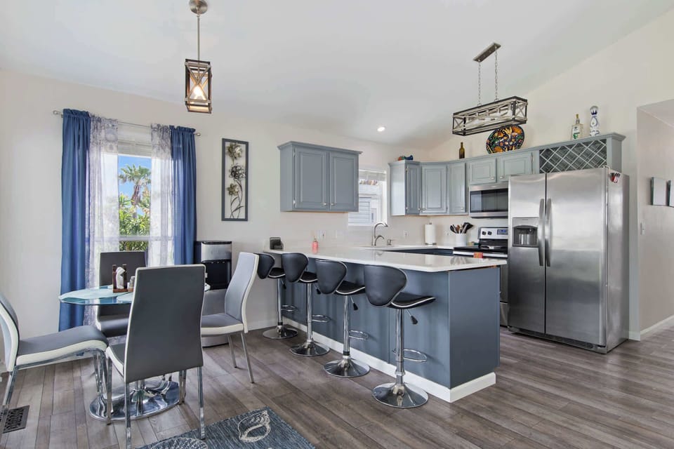 Cook and connect in the open kitchen with breakfast bar and dining nook