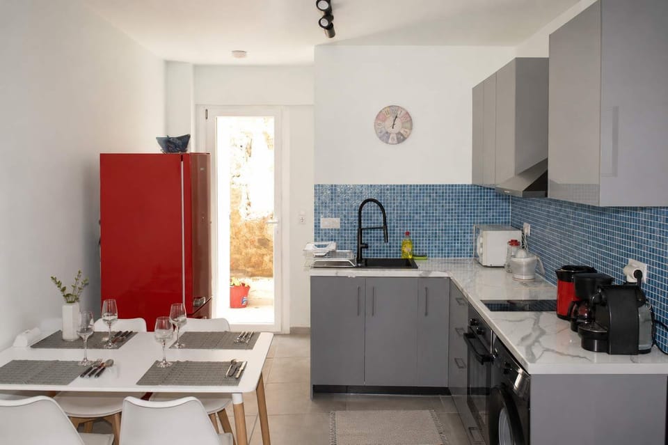Fully Equipped Kitchen with Open Living Space and Red Accent Details