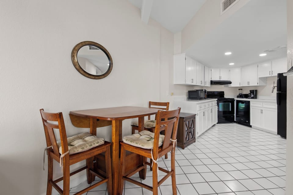 Open dining and kitchen area with a high-top table