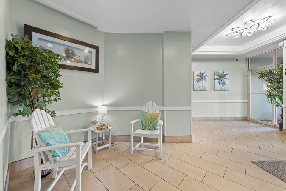 Welcoming building lobby with waiting area and tropical accents