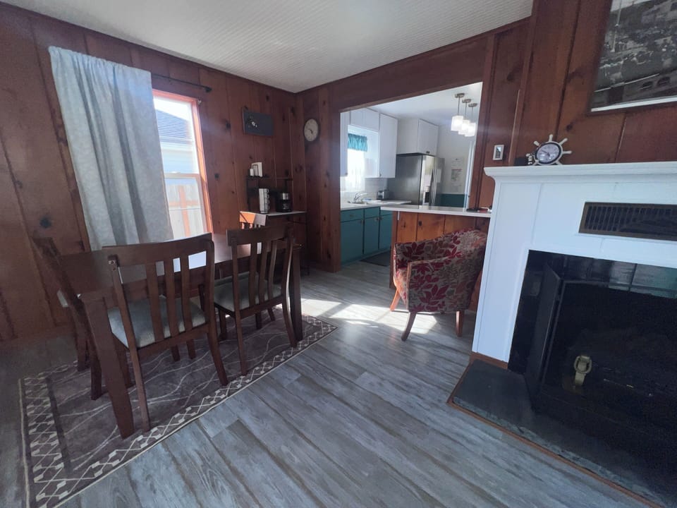 Your rustic hideaway features rich wood paneling, a cozy sleeping loft accessible by ladder, and a compact kitchenette—perfect for a memorable mountain getaway.