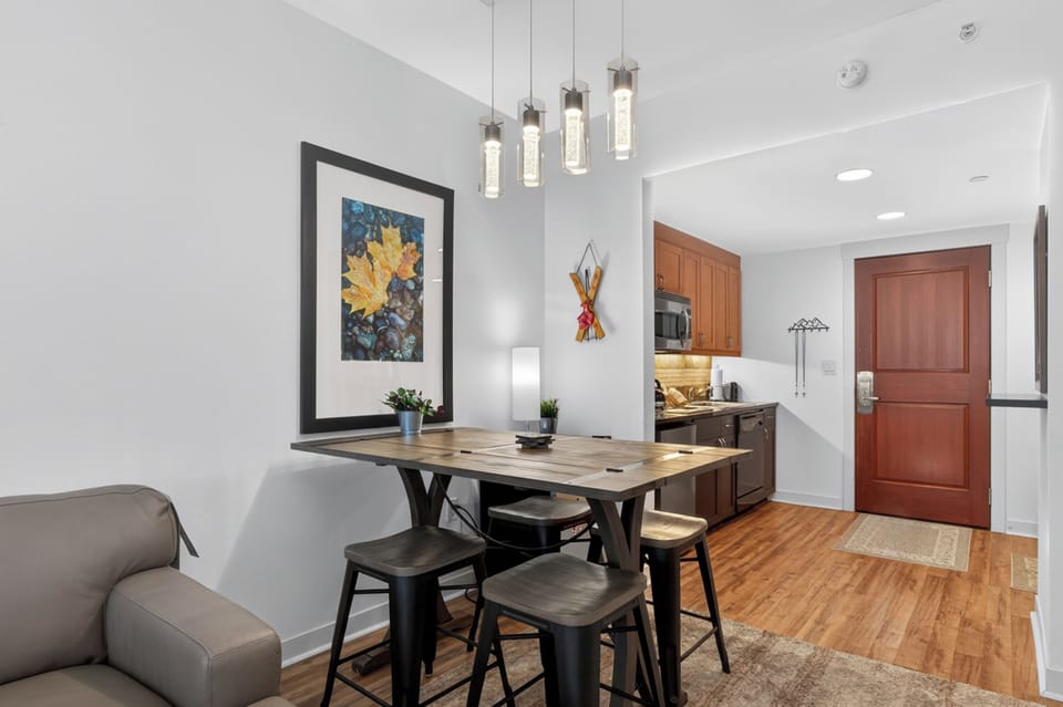Step into your open-concept retreat where a stylish dining nook meets a fully-equipped kitchen—perfect for sharing meals and making memories in a bright, welcoming space.