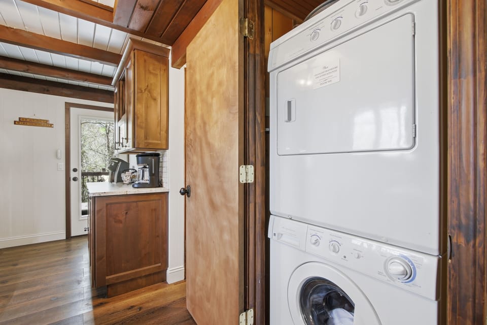 Stacked washer + dryer in the cabin — pack lighter, stay longer