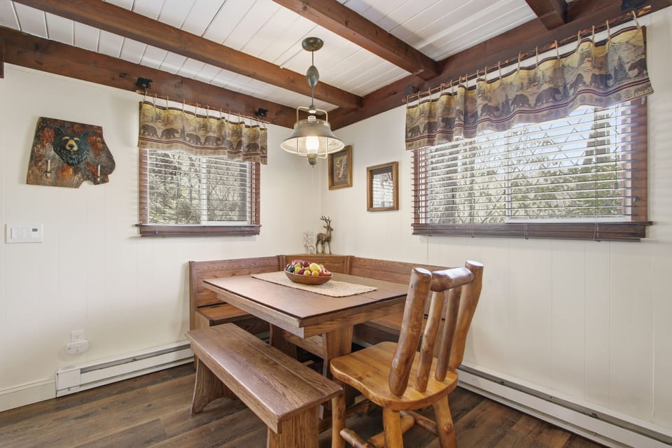 Roomy sectional + chairs by the fireplace — deck access just a step away